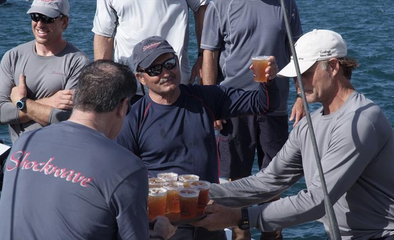 George Sakellaris, owner of the first to finish yacht Shockwave celebrates with Gosling's Dark 'n Stormy drink with his crew on arrival at the Royal Bermuda YC dock after the Newport Bermuda Race photo copyright Barry Pickthall / PPL taken at Royal Bermuda Yacht Club and featuring the IRC class