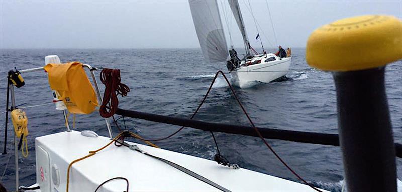 After more than 40 hours of solo racing Deb Fish's Sunfast 3200 Exocet ducks the stern of Jeremy Waitt's JPK10.10 Jangada in the Solo Round the Rock Race photo copyright Jeremy Waitt taken at  and featuring the IRC class