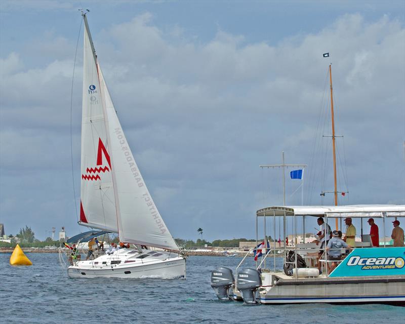 The Hunter 35 Tropic Bird crosses the finish line on Mount Gay Round Barbados Series day 1 photo copyright Peter Marshall / MGRBR taken at Barbados Cruising Club and featuring the IRC class