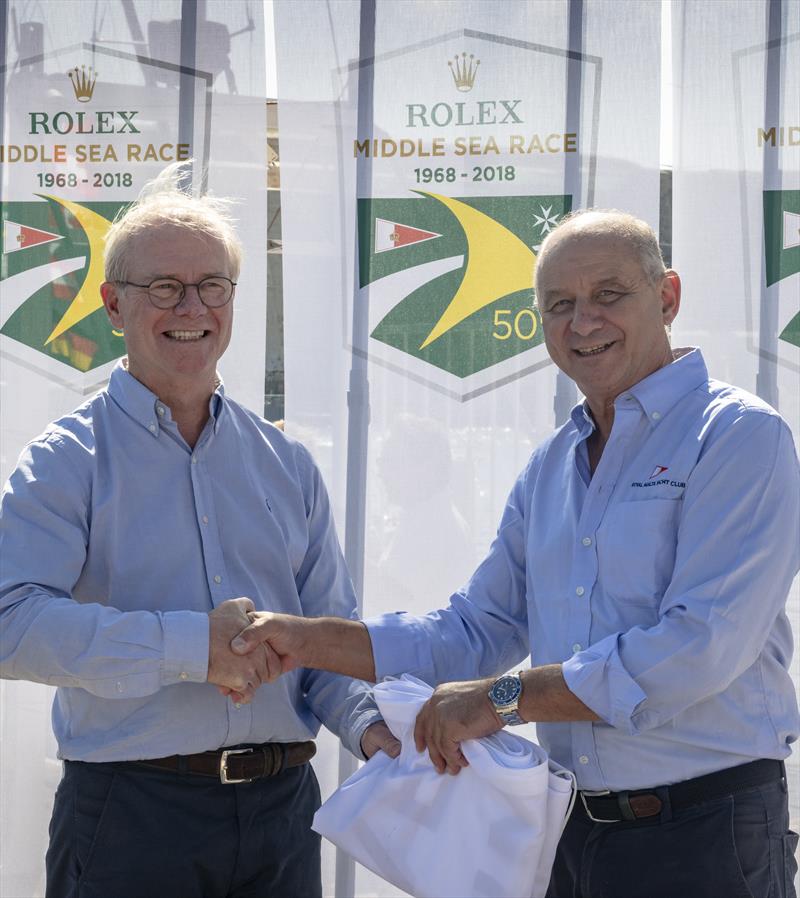 Royal Malta Yacht Club Commodore Godwin Zammit, on the right, presenting the Overall Winner's Flag to Géry Trentesaux in the Rolex Middle Sea Race 2018 - photo © Rolex / Kurt Arrigo