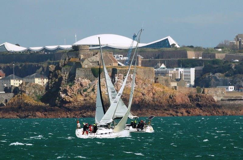 Mystique leads Morrina IV to the finsh line off the Diamond buoy during the RCIYC Commodore's Cup race photo copyright Bernard O'Reagain taken at Royal Channel Islands Yacht Club and featuring the IRC class