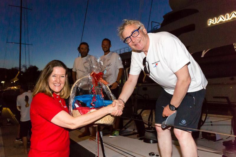Eric de Turckheim, owner of Teasing Machine is presented with a basket of Grenadian produce and welcomed by Patricia Maher, Chief Executive Officer at Grenada Tourism Authority - photo © RORC / Arthur Daniel