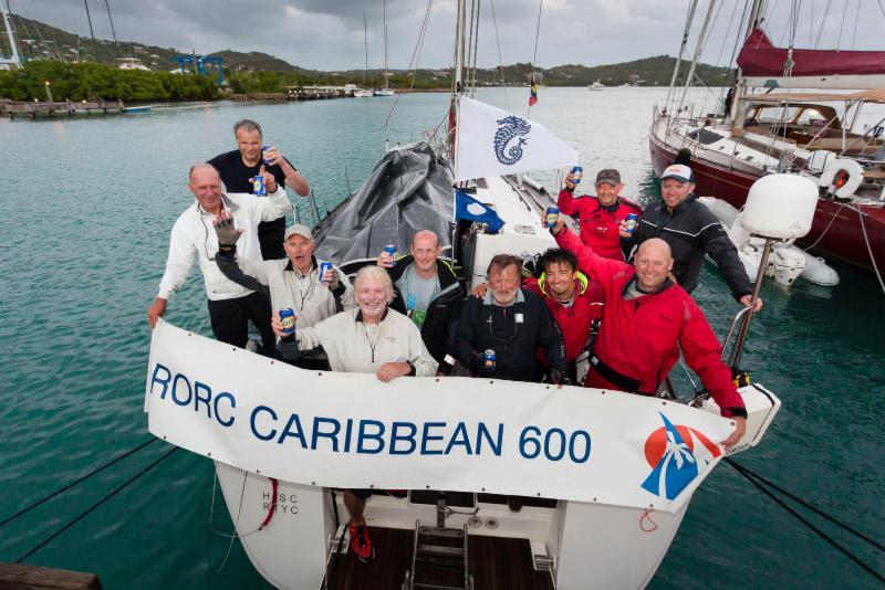 Celebrating their IRC Two victory - Ossie Stewart and Ross Applebey's British Dufour 45, Scarlet Island Girl photo copyright RORC / Arthur Daniel taken at Royal Ocean Racing Club and featuring the IRC class