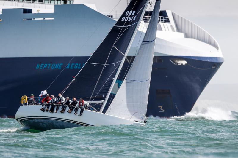 John Smart's J/109 Jukebox is dwarfed by a container ship in the busy Solent waters - 2018 IRC European Championship and Commodores' Cup photo copyright Paul Wyeth / pwpictures.com taken at Royal Ocean Racing Club and featuring the IRC class
