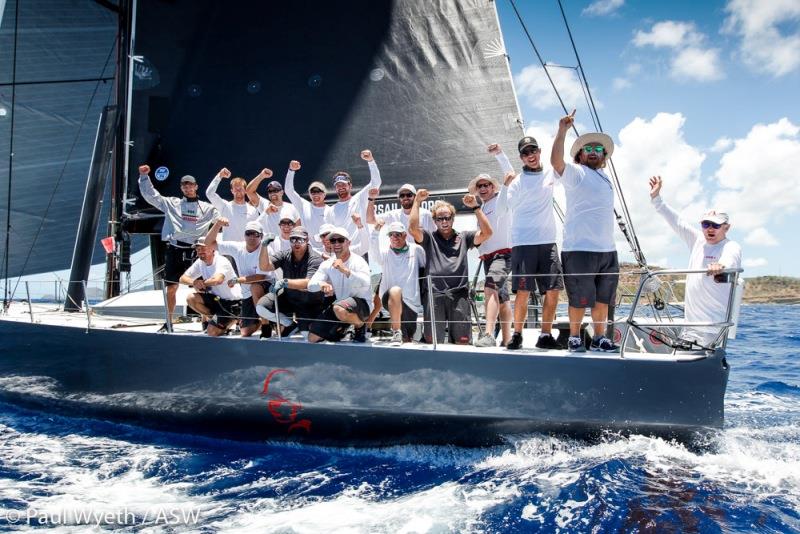 A victorious Warrior crew at the finish of the 2018 Peters & May Round Antigua Race photo copyright Paul Wyeth taken at Antigua Yacht Club and featuring the IRC class