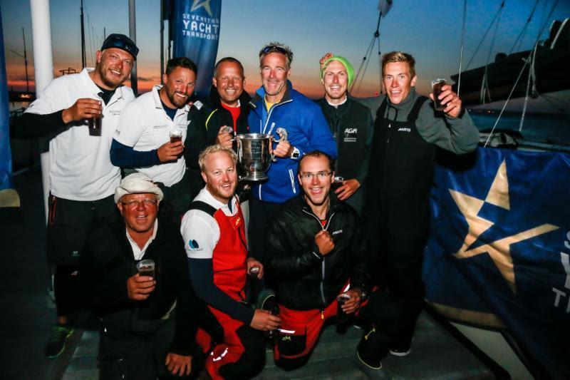Giles Redpath (Centre holding winners trophy for IRC One) and crew celebrate dockside photo copyright Paul Wyeth / RORC taken at Royal Ocean Racing Club and featuring the IRC class