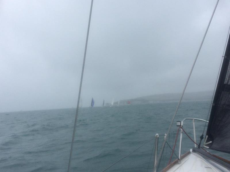 PYRA fleet head towards Old Harry Rocks off Poole in less than delightful conditions photo copyright Mike Fox taken at Poole Yacht Racing Association and featuring the IRC class
