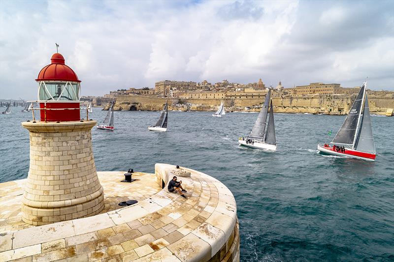 The city of Valletta provides the backdrop as the Rolex Middle Sea Race fleet exit the Grand Harbour photo copyright Rolex / Kurt Arrig taken at Royal Malta Yacht Club and featuring the IRC class