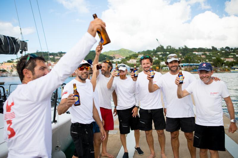 Kuka3 crew enjoy a cold beer to celebrate their victory, courtesy of Camper & Nicholsons Port Louis Marina - 2018 RORC Transatlantic Race photo copyright RORC / Arthur Daniel taken at Royal Ocean Racing Club and featuring the IRC class