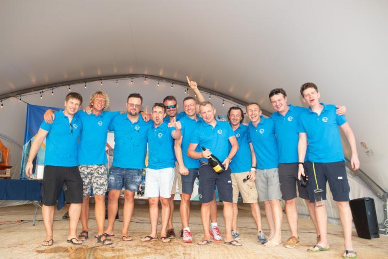 The crew of E1 Volvo 70 skippered by Rafal Sawicki celebrate at the awards ceremony at Nanny Cay in the Regatta Village - Round Tortola Race 2019 photo copyright Alastair Abrehart taken at Royal BVI Yacht Club and featuring the IRC class