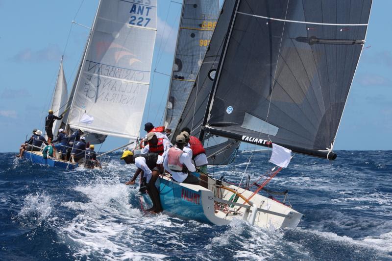 Showing great sportsmanship and camaraderie: Joshua Daniels, keelboat instructor at the National Sailing Academy with his young crew on NSA Valiant - Antigua Sailing Week photo copyright Tim Wright / www.photoaction.com taken at Antigua Yacht Club and featuring the IRC class