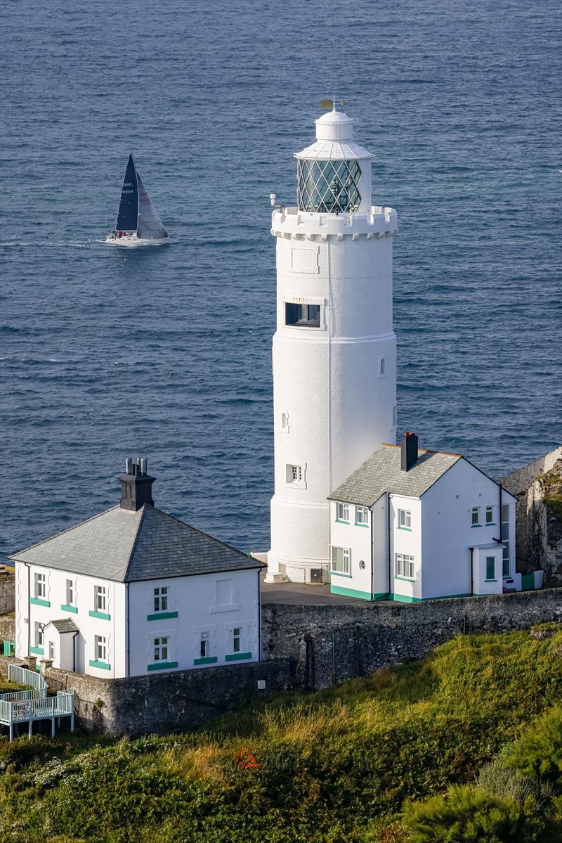A competitor passes Start Point Lighthouse on south coast of England - Rolex Fastnet Race photo copyright Carlo Borlenghi taken at Royal Ocean Racing Club and featuring the IRC class