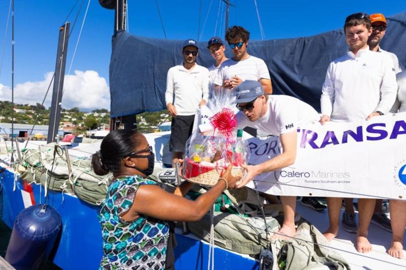 Receiving a beautiful basket of Grenadian fine produce (and rum!) from Grenada Tourism Authority on arrival. - photo © Arthur Daniel / RORC