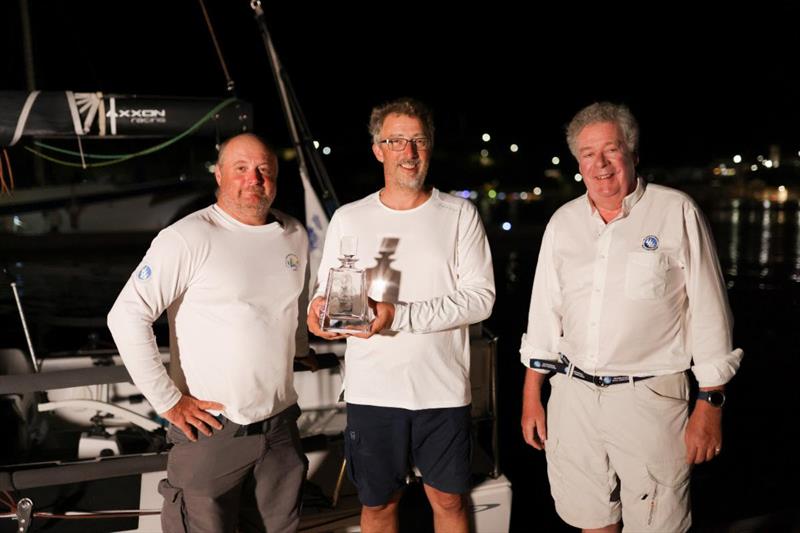Andrew Mcirvine, IMA Secretary General and past RORC Admiral greets Team Jangada and presents them with the trophy for winning the RORC Transatlantic Race IRC Two-Handed class - photo © Arthur Daniel / RORC