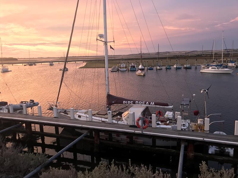 Sunset QCYC with Commodore Lee Renfree's boat PipeDream moored at wharf - photo © Lee Renfree