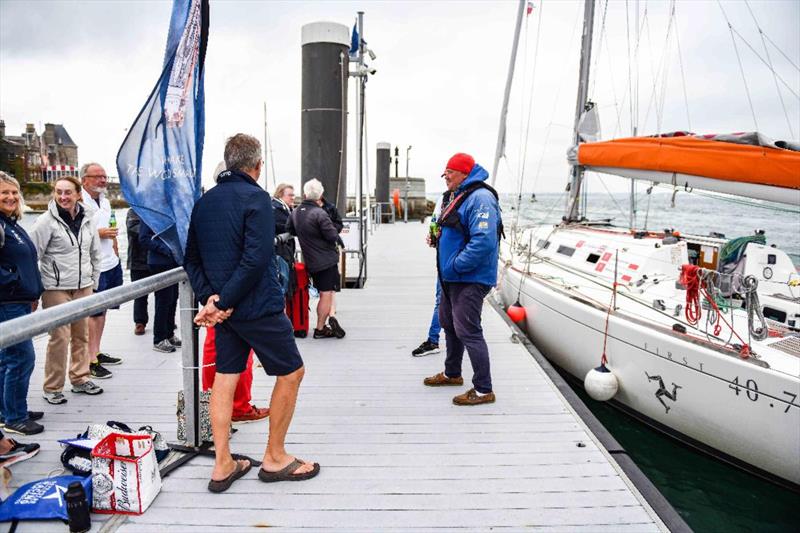 A great welcome on the dock for Kuba and Adrian - photo © James Tomlinson / RORC