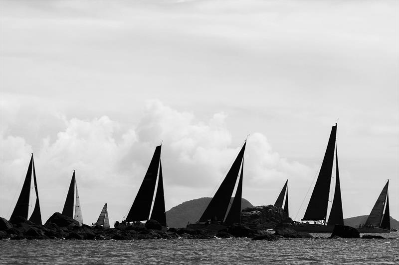 Fleet passes a rocky outcrop - 2023 Airlie Beach Race Week - photo © Andrea Francolini / ABRW