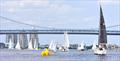The sailing fleet competes with the Ben Franklin Bridge in the background during the 2024 Philadelphia Cup Regatta