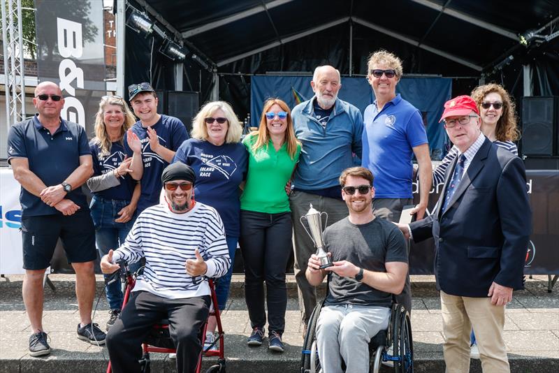 Round the Island Race 2025 - The Disabled Sailors Association, with Dale holding the first in class trophy - photo © Paul Wyeth / www.pwpictures.com