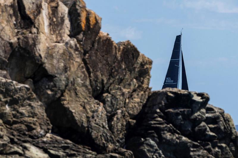 Kiwi entry V5 (Brian Petersen) appears behind a rocky outcrop - Islands Distillery Airlie Beach Race Week - photo © Andrea Francolini / ABRW