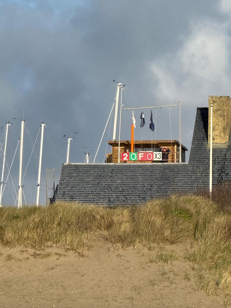 Pwllheli Winter Series Weekend 2 - Robin Evans displays the course cards on the Pwllheli Sailing Club Bridge - photo © Vicky Cox