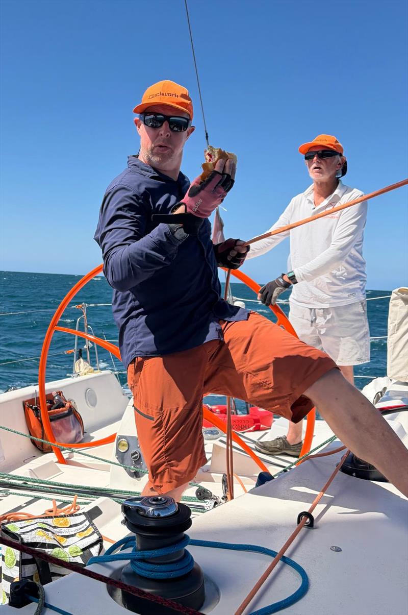 Tom Ibbott multitasking while Andy Lloyd steers Clockwork - on day 2 of SeaLink Magnetic Island Race Week 2026 - photo © Mary Ann Harvey, Clockwork