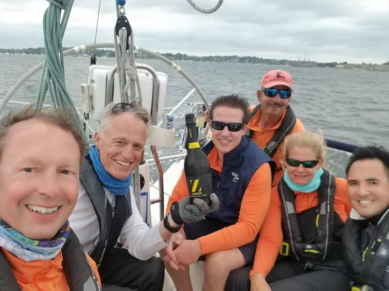 Vento Solare's team collecting its finish-line champagne in the 2020 Ida Lewis Distance Race IN BAY event photo copyright Stephen Cloutier taken at Ida Lewis Yacht Club and featuring the J109 class