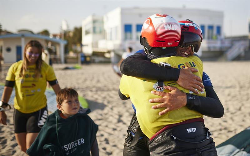 2023 Kitefoil World Series - Congratulatory hug for Maeder from silver medallist Boschetti photo copyright IKA Media / Robert Hajduk taken at  and featuring the Kiteboarding class