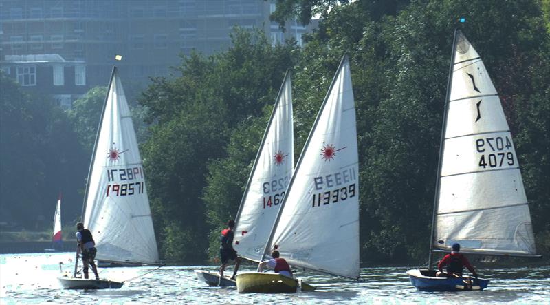 Andy Banks in the winning Solo alongside the leading Lasers, under the trees of Hampton Court Home Park at the Minima Regatta - photo © Rob Mayley