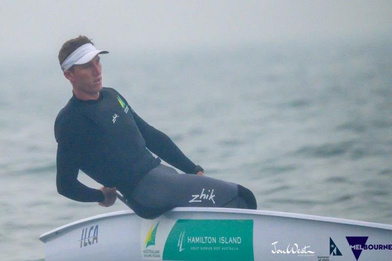 Luke Elliott (AUS) shrouded in smoke on his way to a win in Race 6 of the Australian Laser Championships photo copyright Jon West Photography taken at Sandringham Yacht Club and featuring the ILCA 7 class