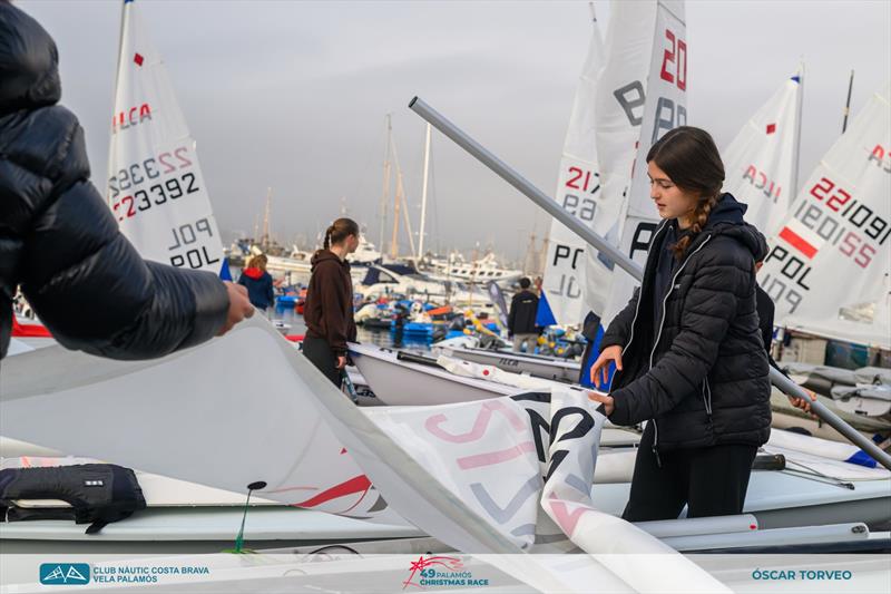 The sailors preparing their boats - 49th Palamós Christmas Race Day 2 photo copyright Oscar Torveo taken at  and featuring the ILCA 4 class