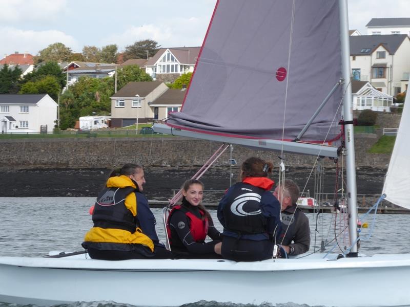 Shania in the red lifejacket in the middle of the boat looking at camera, Mum Kirsty in the yellow lifejacket at the back of the boat photo copyright RYA Cymru-Wales taken at RYA Cymru-Wales and featuring the Laser Bahia class