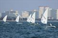 ILCA 6 fleet downwind with the Pattaya skyline in the background on day 1 of the Open Masters Championship 2026