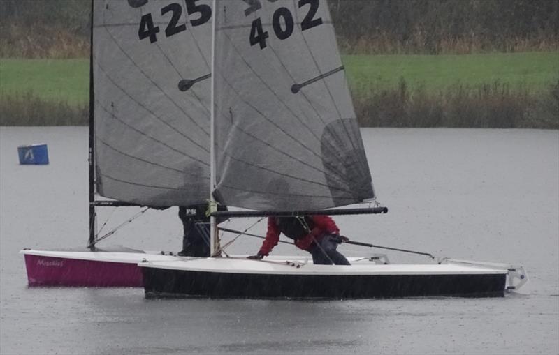 Winner Penny Harris passes Stephen Hodgson in torrential rain during the Allen Brothers Lightning 368 Inlands at West Oxfordshire SC photo copyright Robbie Claridge taken at West Oxfordshire Sailing Club and featuring the Lightning 368 class