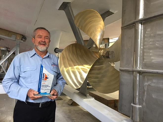 Alan Steber, latest AIMEX trophy in hand, is dwarfed by the prop of the 60ft fisheries research vessel under construction for the government of Mauritius photo copyright John Bulmer taken at  and featuring the Marine Industry class