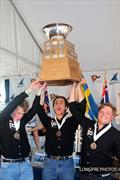 Winners of the 55th Governor's Cup Jordan Stevenson, Mitch Jackson, and George Angus (NZL) hoisting the Governor's Cup trophy © Longpre Photos