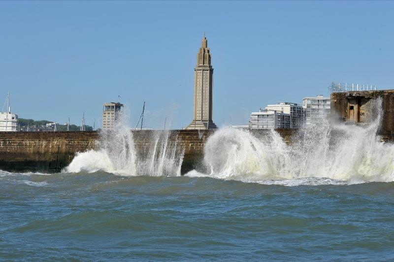 The waves crash on the outer breakwater of Le Havre with Saint Joseph's Church in the background on day 2 of the Normandie Match Cup (WIM Series) photo copyright Patrick Deroualle taken at  and featuring the Match Racing class