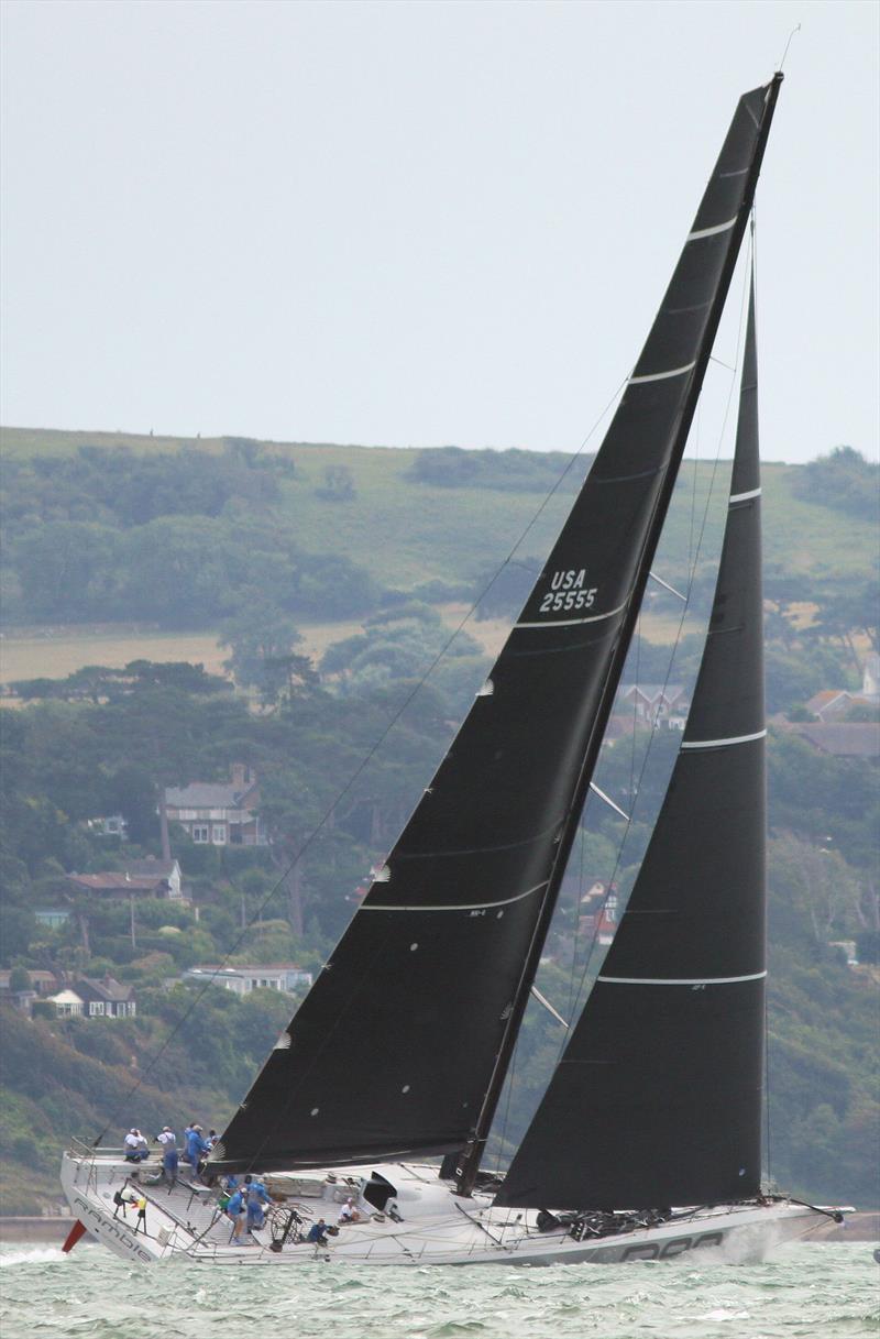 Rambler 88 passes Hurst Castle in the 2019 Rolex Fastnet Race photo copyright Mark Jardine taken at Royal Ocean Racing Club and featuring the Maxi class