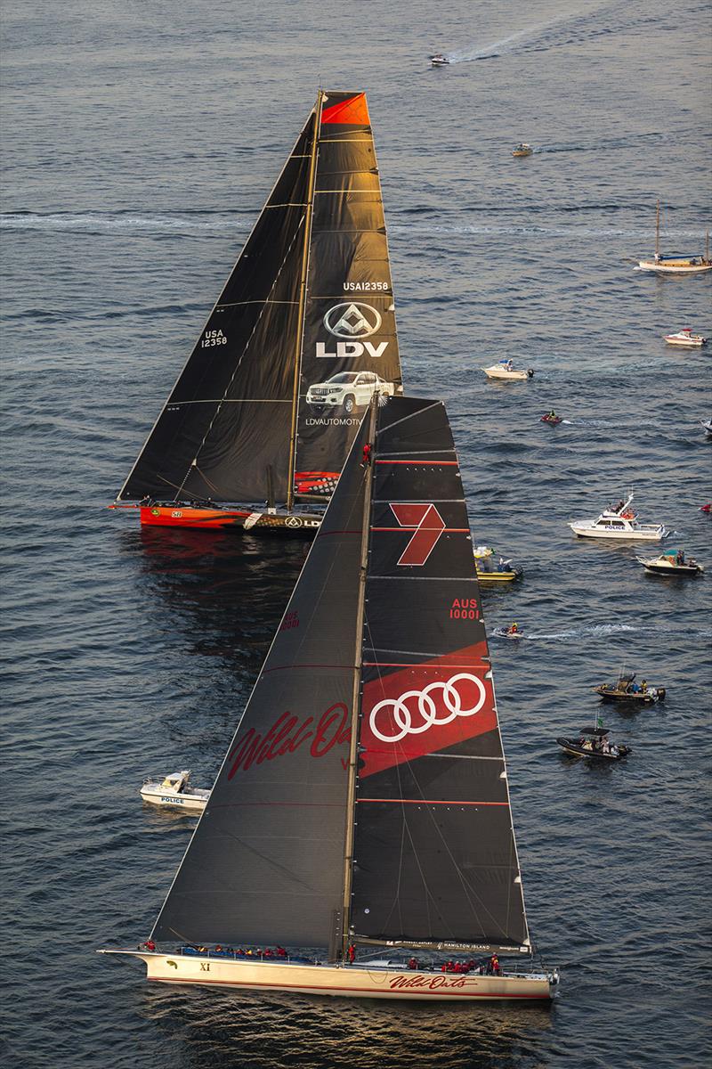 In the river on the way to Hobart and Wild Oats XI begins to overtake LDV Comanche. Note crewman up on the first spreader photo copyright Andrea Francolini taken at Cruising Yacht Club of Australia and featuring the Maxi class