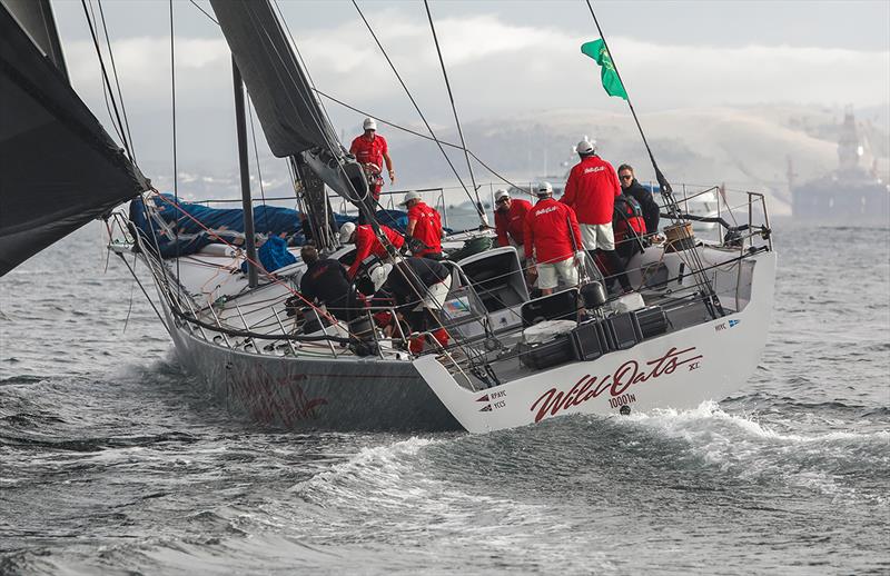 Wild Oats XI passes the oil rig parked in the Derwent River - photo © Crosbie Lorimer