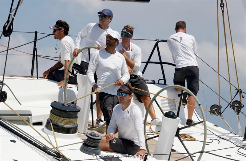 Owner Miguel Galuccio at the helm of line honours favourite, Vera photo copyright Event Media taken at Yacht Club Costa Smeralda and featuring the Maxi class