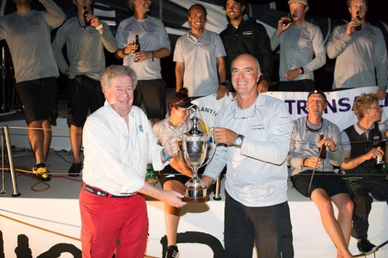 Bouwe Bekking, Skipper of VO65 Childhood 1 receives the International Maxi Association Trophy for monohull line honours from  IMA Secretary General, Andrew McIrvine after completing the RORC Transatlantic Race in Grenada with his young crew photo copyright RORC / Arthur Daniel taken at Royal Ocean Racing Club and featuring the Maxi class