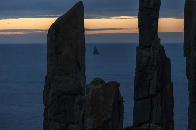 InfoTrack, owned by Christian Beck, passing Tasman Island during the Sydney to Hobart race on December 28 photo copyright Andrea Francolini taken at Royal Yacht Club of Tasmania and featuring the Maxi class