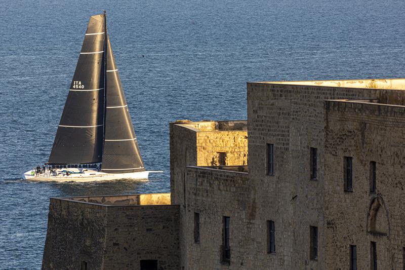 Alessandro del Bono's Capricorno sets sail from off Naples' historic Castel dell'Ovo. - 2022 IMA Maxi European Championship photo copyright ROLEX / Studio Borlenghi taken at Circolo del Remo e della Vela Italia and featuring the Maxi class