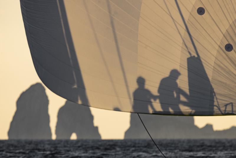 Foredeck crew in the evening light approaching Capri's famous Faraglioni rocks. - photo © ROLEX / Studio Borlenghi