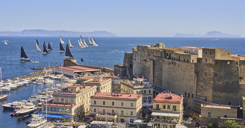 The fleet sets sail from Naples' Porticciolo di Santa Lucia and its famous Castel dell'Ovo photo copyright Tre Golfi Sailing Week / Studio Borlenghi taken at Circolo del Remo e della Vela Italia and featuring the Maxi class