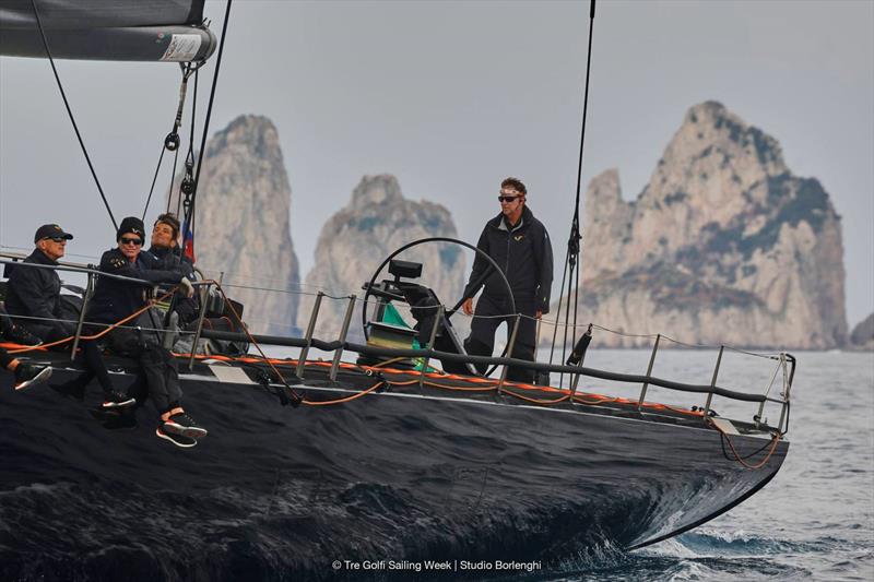 Tactician Ken Read directs the 100ft V past Capri's Faraglioni rocks - photo © Tre Golfi Sailing Week / Studio Borlenghi