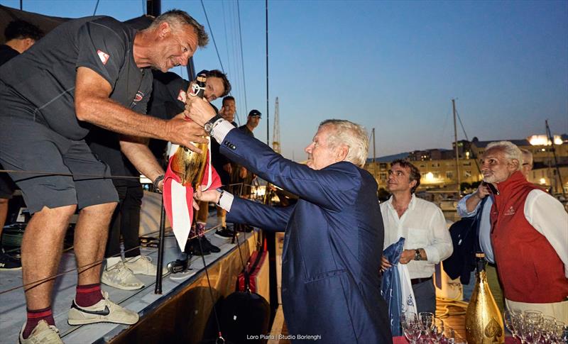 YCCS President Carlo Cameli presents SHK Scallywag skipper David Witt with some liquid refreshment for the crew - photo © Loro Piana / Studio Borlenghi