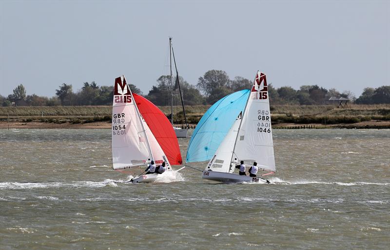 64th Endeavour Trophy - Thomas Murphy & Sam Spencer (1054, Topper 4.2) and Graham & Blue Camm (1046, National 12) crossing gybes at speed photo copyright Mark Jardine taken at Royal Corinthian Yacht Club and featuring the Melges 15 class