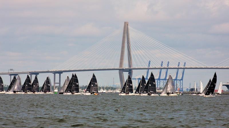 The Melges 24 fleet beats upwind with the Arthur Ravenel Jr. Bridge in the background on Sunday - 2021 Charleston Race Week photo copyright Willy Keyworth taken at Charleston Yacht Club and featuring the Melges 24 class